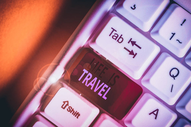 Handwriting text Life Is Travel. Conceptual photo Exposure to the diversity Tourism Promoting Landmarks White pc keyboard with empty note paper above white background key copy space - Fotó, kép