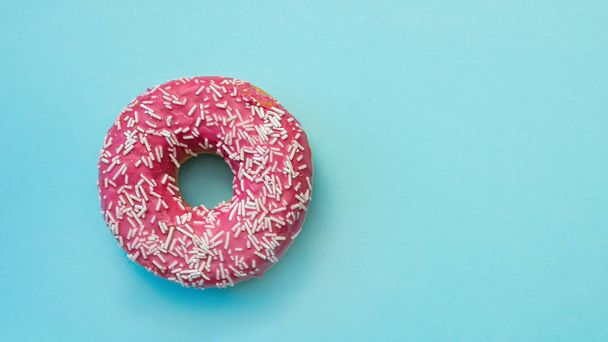 Donuts with icing on pastel blue background. - Photo, Image
