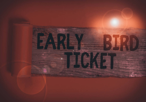 Word writing text Early Bird Ticket. Business photo showcasing Buying a ticket before it go out for sale in regular price Cardboard which is torn in the middle placed above a wooden classic table - Photo, Image