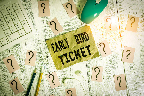 Text sign showing Early Bird Ticket. Business photo showcasing Buying a ticket before it go out for sale in regular price Writing tools, computer stuff and scribbled paper on top of wooden table - Photo, Image