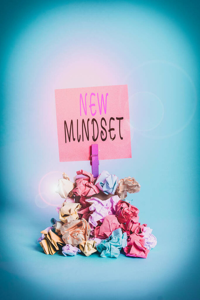Text sign showing New Mindset. Business photo showcasing Mental attitude or disposition New approach in dealing situation Reminder pile colored crumpled paper clothespin reminder blue background - Photo, Image