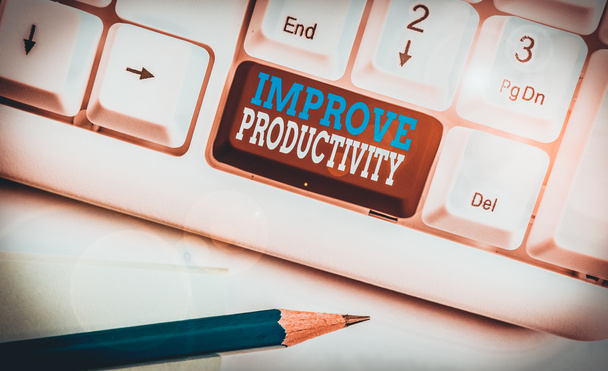 Conceptual hand writing showing Improve Productivity. Concept meaning to increase the machine and process efficiency White pc keyboard with note paper above the white background - Photo, Image