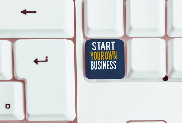 Conceptual hand writing showing Start Your Own Business. Concept meaning Entrepreneurial Venture a Startup Enter into Trade White pc keyboard with note paper above the white background - Photo, Image