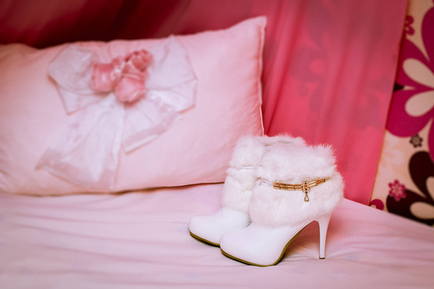 Women's white ankle boots with fur on a pink background. Accesso - Photo, Image