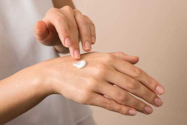 skincare. close up view of woman hand moisturising them with cream. skincare - Photo, image