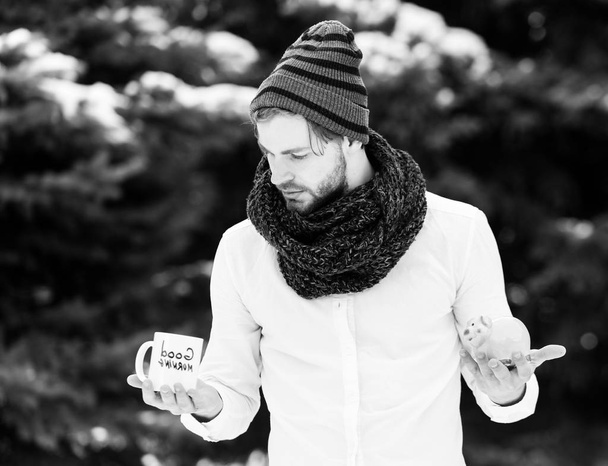 handsome man with moneybox and cup in winter outdoor - Φωτογραφία, εικόνα