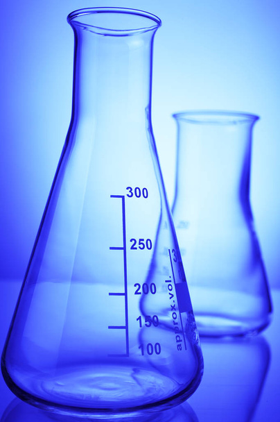 laboratory glassware with blue liquid on white background - Foto, imagen