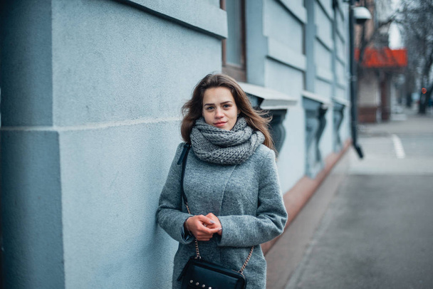 Girl in a gray coat in the winter in the city - 写真・画像