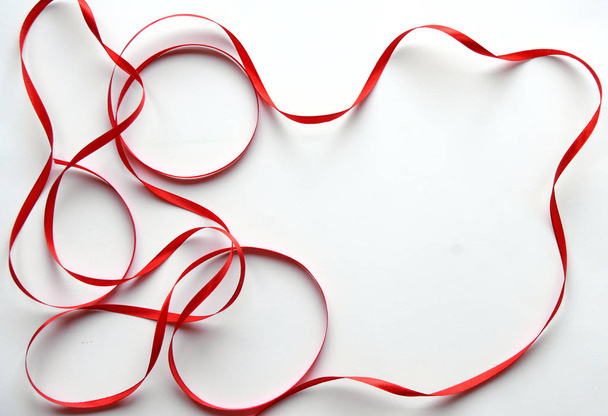 Shiny red ribbon frame on white background with copy space. - Photo, image