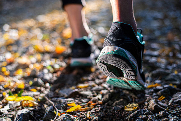 Closeup of footwear of a female runner getting ready for a trail - Foto, Imagem