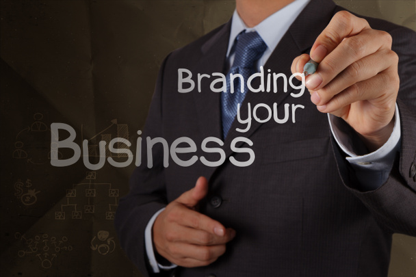 businessman hand writing branding your business with crumpled re - Photo, Image