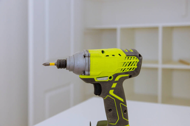 Electric cordless screwdriver drill tools on wooden desk - Photo, Image