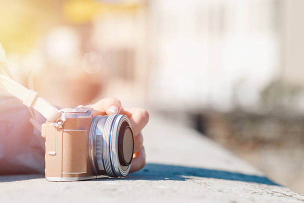 Close-up mão de menina segurando pequena câmera no fundo borrado, espaço de cópia
 - Foto, Imagem