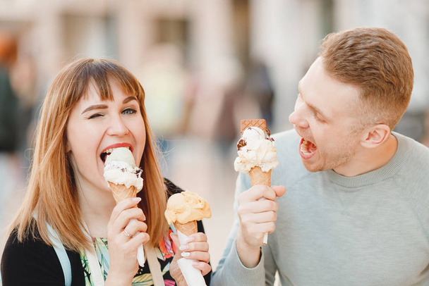 Cheerful couple man and girl friends in Rome eating Italy ice cream cones - Photo, Image