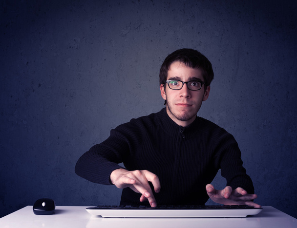 Hacker working with keyboard on blue background - Zdjęcie, obraz