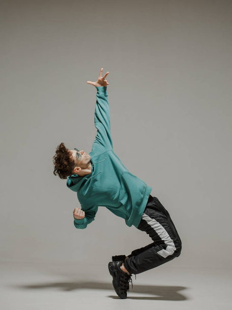 Boy dancing contemporary dance in studio. Acrobatic dancer. - 写真・画像