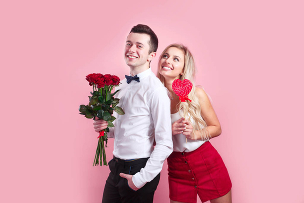 Portrait of happy couple on Valentines Day on pink background. - Photo, Image