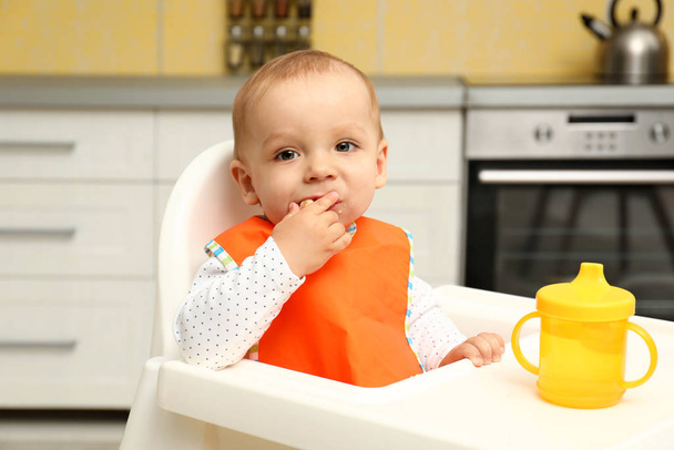 Cute little baby eating cookie at home - Photo, Image