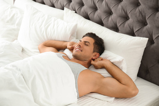 Man awakening on bed at home. Lazy morning - Foto, imagen