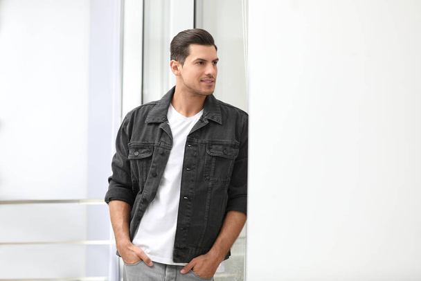 Handsome man wearing casual outfit near window at home - Photo, image
