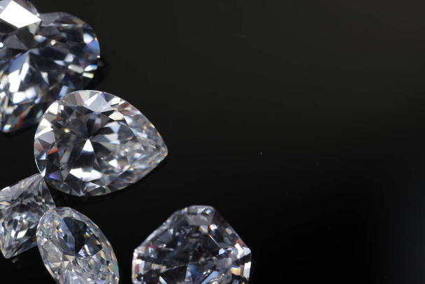 Macro shoots of a group of diamonds that has different shapes, heart, round, pear, asscher, oval, princess, isolated background - Photo, Image