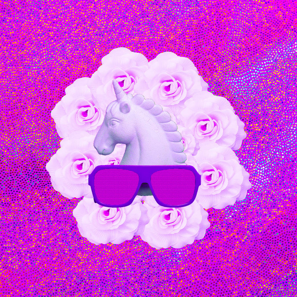 Unicornio blanco pintado y gafas de sol con estilo en el espacio rosa de la floración
 - Foto, imagen