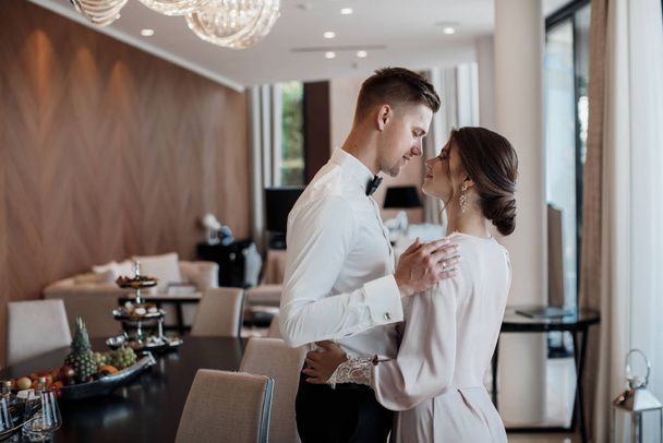 Loving couple at the hotel on a honeymoon.Just married. Honeymoon concept. Romantic relations. True love. Family love. Couple in love. Cute relationship. Man and woman cuddle nature background.  Together forever. Love story of the newlyweds. - Foto, Imagem