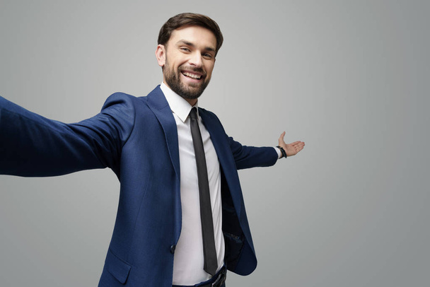 wide angle selfie shot of a young businessman pointing on a copyspace with his hand - Photo, image