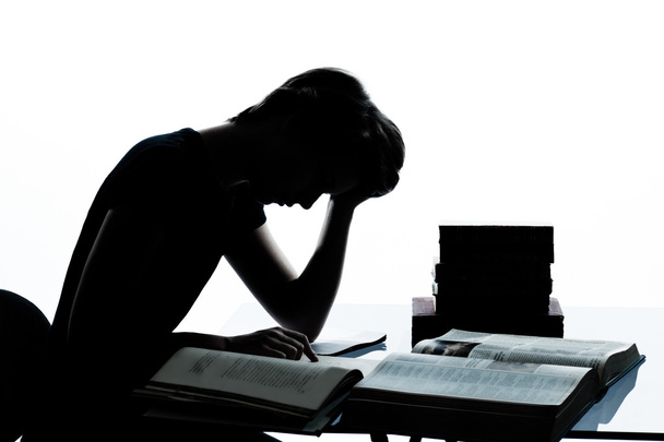 one young teenager boy girl silhouette studying reading books ti - Zdjęcie, obraz