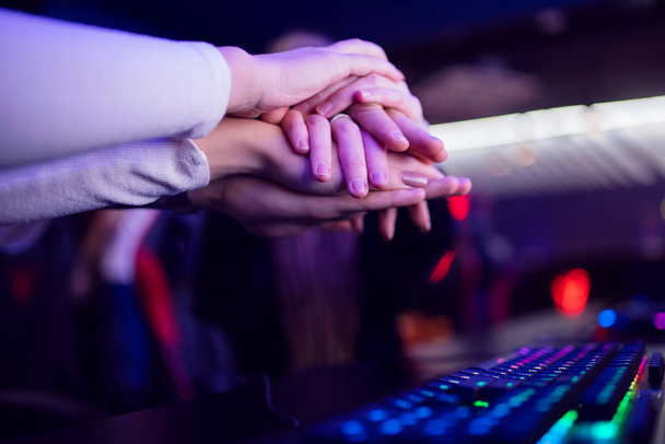 Hand of team man and girl professional gamer playing tournaments online games computer with headphones - Φωτογραφία, εικόνα
