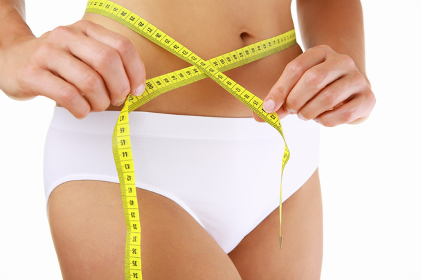 Woman measuring her slim body - Photo, Image