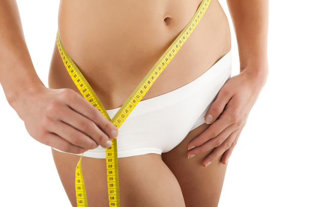 Woman measuring her slim body - Photo, image