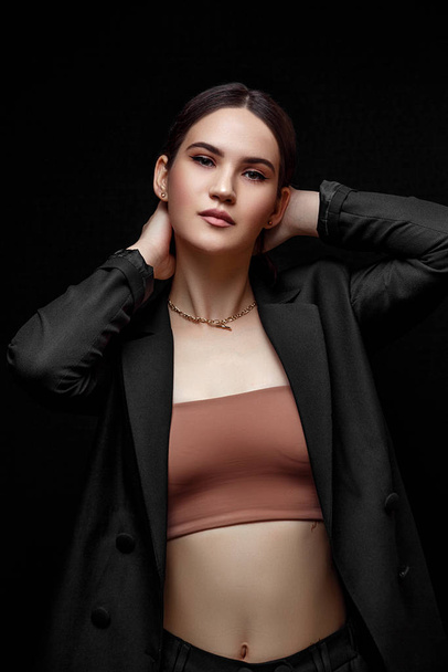 High fashion portrait of young elegant woman in black suit and b - Foto, Imagen