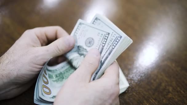 Man counting dollar bills. Close up of male hands count money cash - Кадри, відео