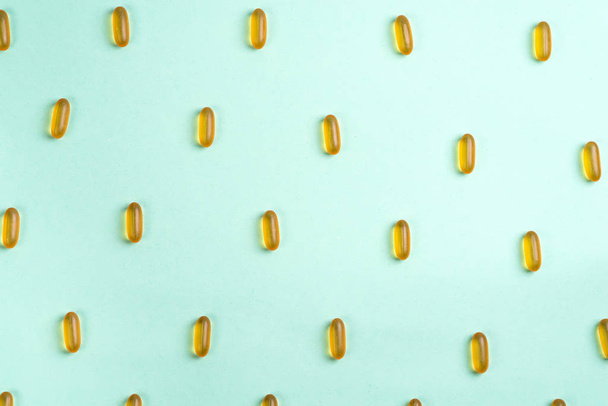 Omega 3 fish oil capsules isolated on a blue background - 写真・画像