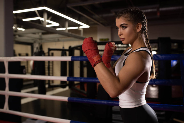 Muscular woman boxer isolated in gym - Valokuva, kuva