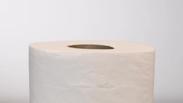 Toilet roll rotating slowly, isolated on white background, rotation - Záběry, video