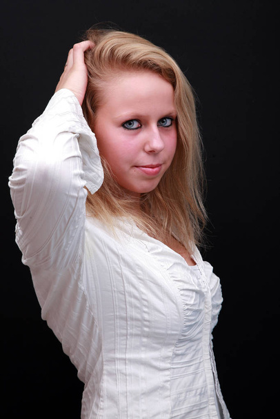 portrait of a beautiful blonde girl in a white shirt - 写真・画像