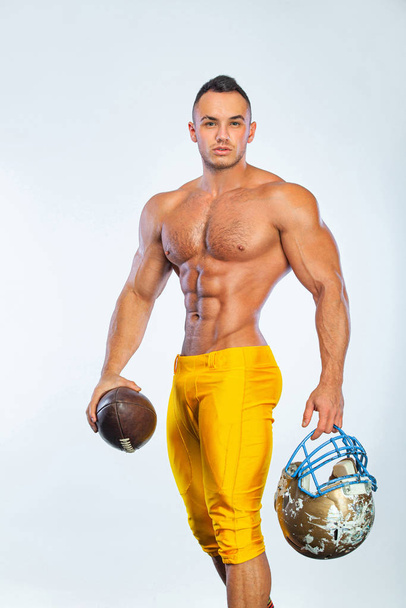 Gay streptizer with naked torso. American football player in helmet isolated on white background. - Foto, Imagen