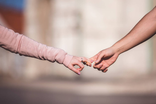 Two lovers hold hands together, selective focus - Фото, зображення