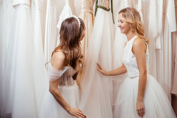 two young women choosing dress for wedding - Foto, Imagem