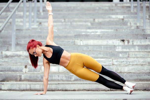 Athletic woman doing sports training, side planks and jogging outdoors - Foto, immagini