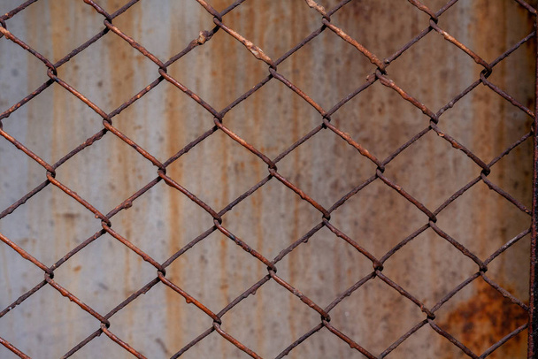 Rusty mesh background texture. Stock photo focus on a rusty sect of the fence. - Fotó, kép