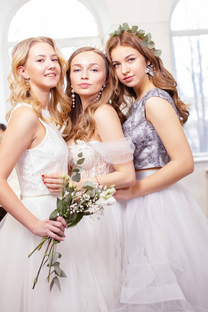 three caucasian girlfriends try on wedding dresses - Foto, Imagen