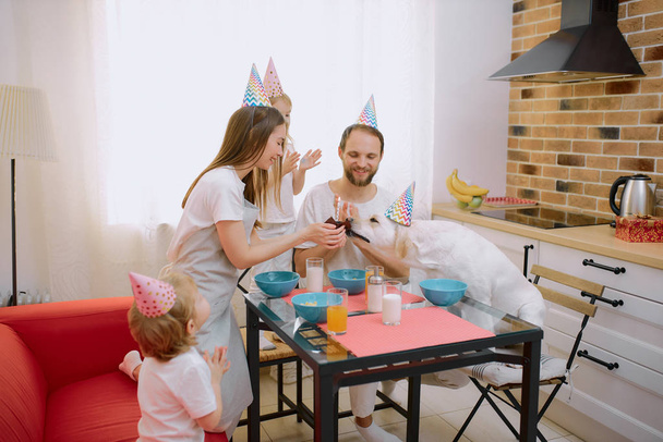 caucasian family consisted of mother, father, children and dog celebrating birthday - Foto, Bild
