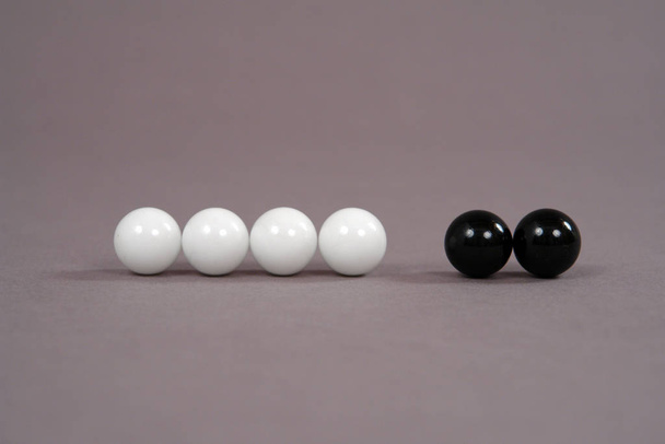 white and black beads on a gray background - Foto, Imagen