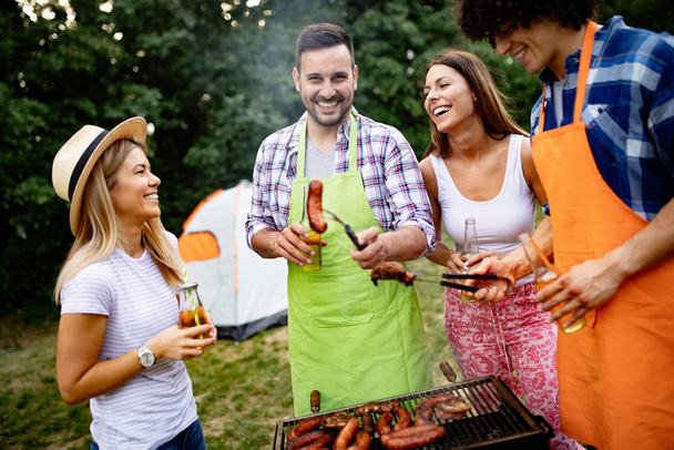 Friends having a barbecue party in nature while having a blast - Foto, Imagem
