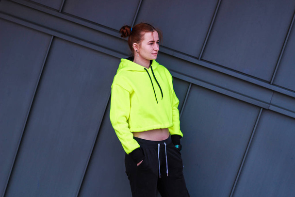 Girl in fluorescent yellow crop top. Stylish streetwear for teen - Φωτογραφία, εικόνα