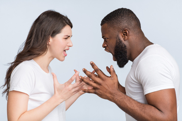 Multiracial couple quarreling, shouting at each other, having relationship problems - 写真・画像