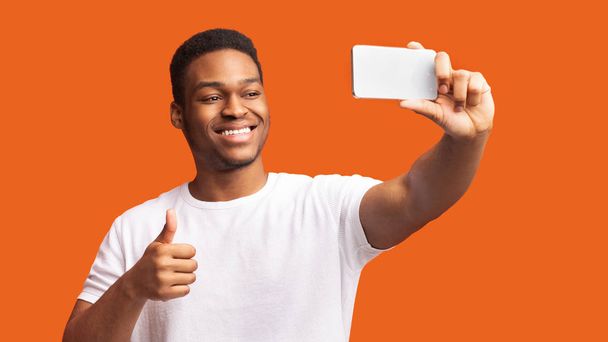 Headshot of afro guy taking selfie at studio - Photo, Image